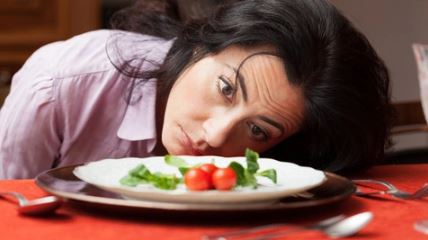 Woman beside a plate of food