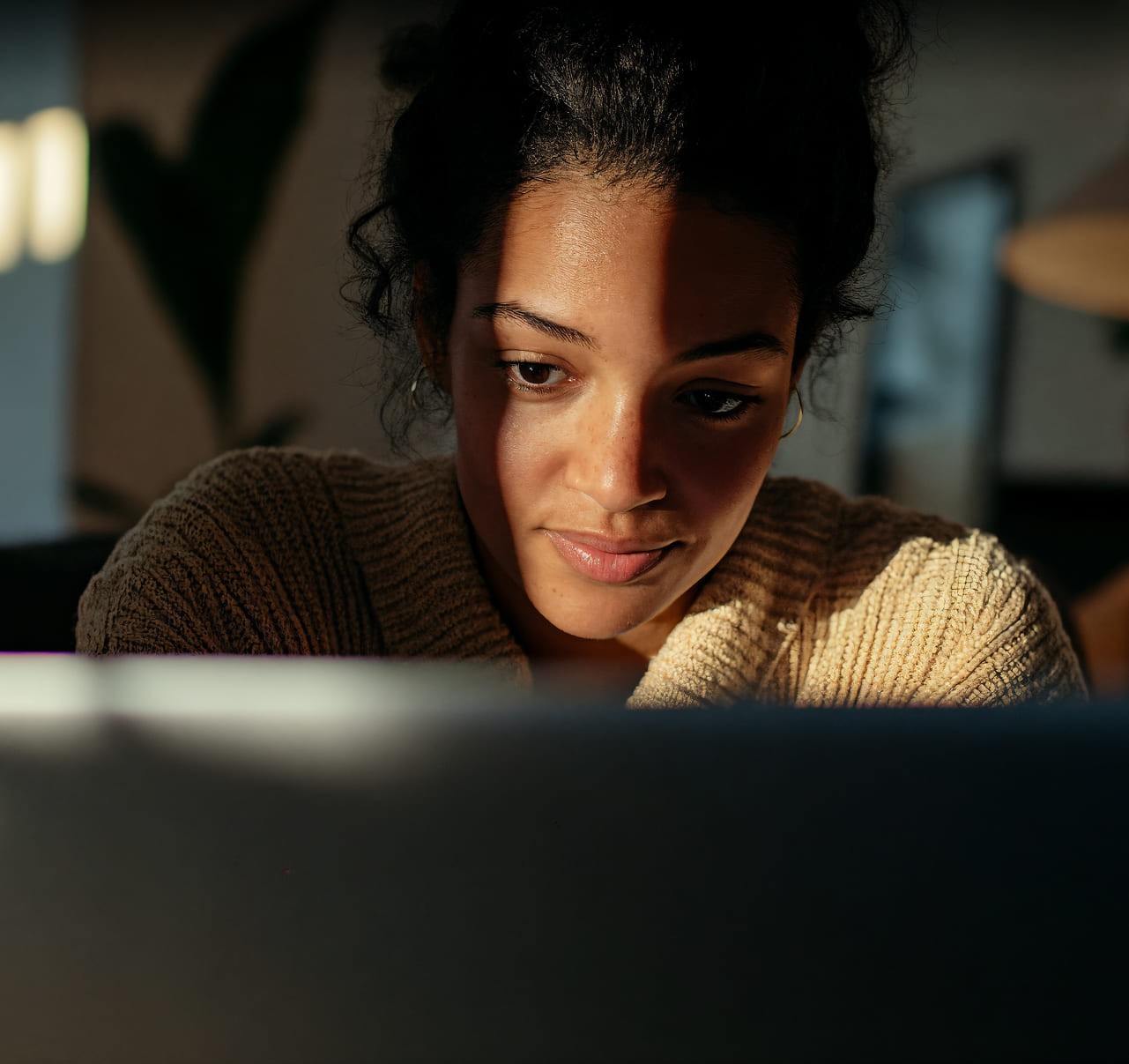 A woman in thoughts looking at her screen
