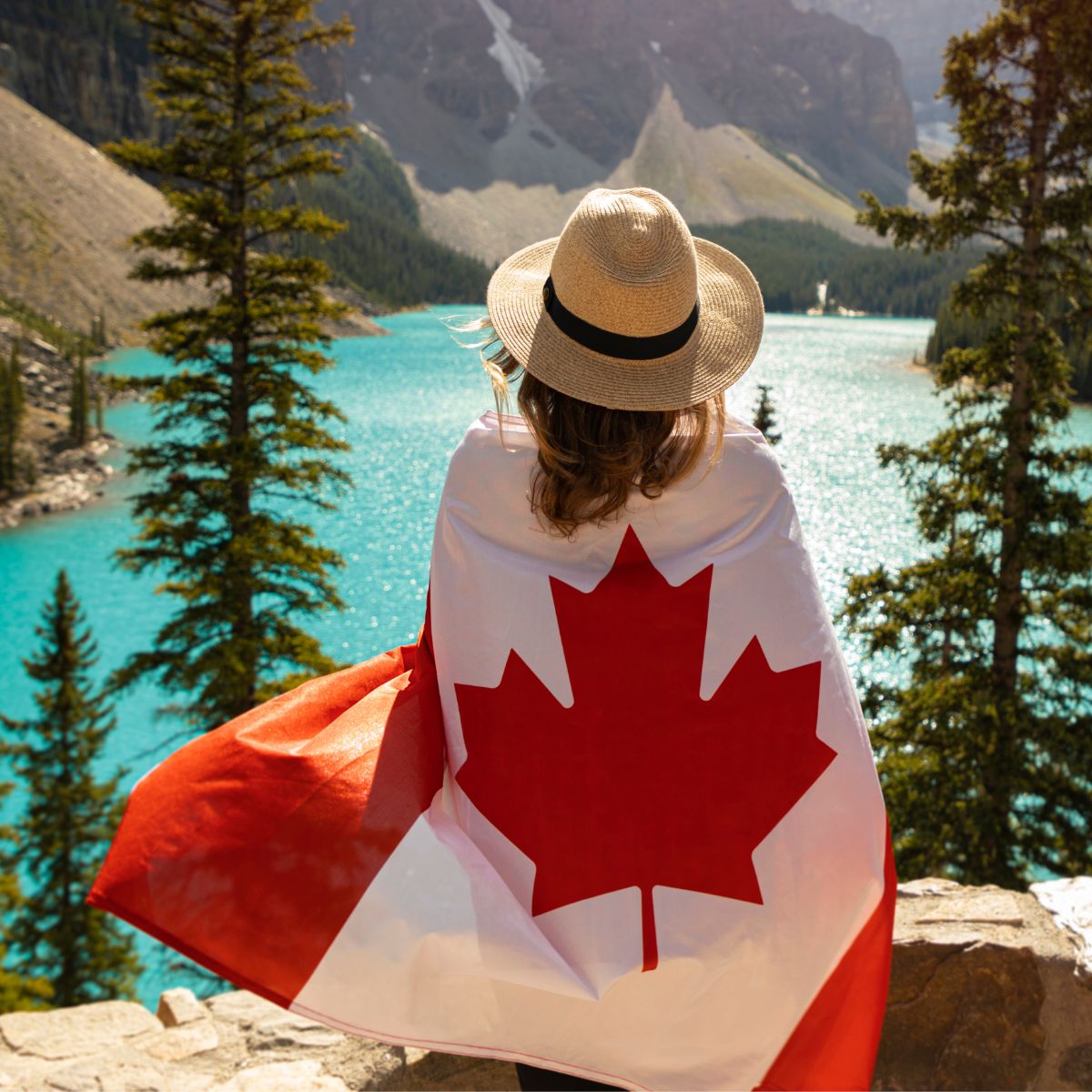 Nhà đầu tư khoác cờ Canada bên hồ nước tại Alberta