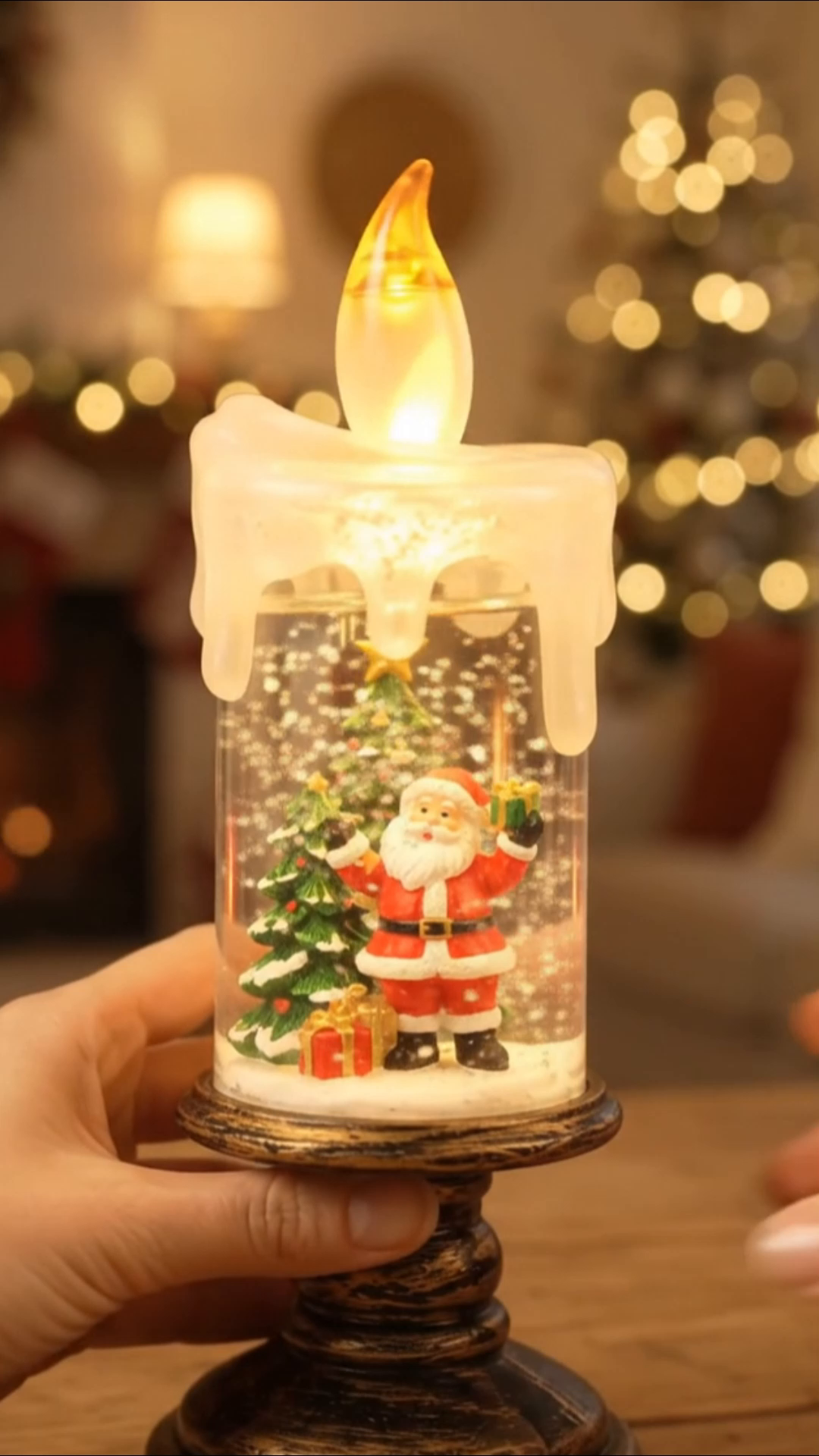 LED snow globe candle glowing warm light at night