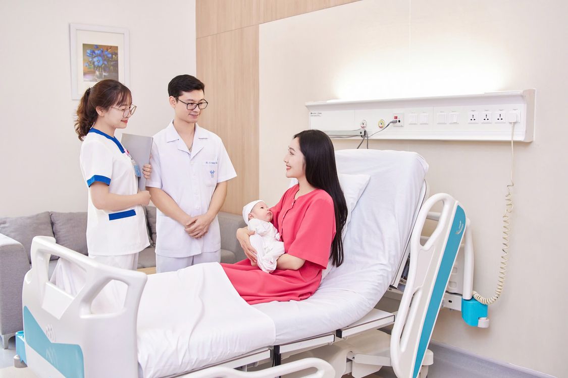 Bác sĩ và hộ sinh thăm khám cho mẹ tại phòng bệnh
